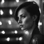 Placeholder: close-up portrait of a girl in a dark room, in profile, eyes raised up, looking to the side, short hair, behind her there is a light highlight on the wall, stylish black and white photography in the style of Peter Lindbergh