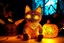 Placeholder: Against a dark cracked holographic marble background, a cute chibi plushy fluffy knitted and embroidered cat, tent, campfire, pond, mist and fog in sunshine, drawn in orange glowing neon lines. The cracks in the background are golden. Ethereal, cinematic postprocessing.