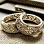 Placeholder: Elegant and intricate gold wedding bands with diamond accents