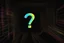 Placeholder: black background, outlines of a holographic question mark drawn from thin neon-coloured glowing lines