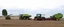 Placeholder: Parked at the edge of a field is a Claas brand Combine(left)seeder(middle) and a John Deere Tractor with seeder(right) simplified