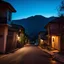 Placeholder: A night photography depicting a street going up to a moutain, with odd houses, horror movie shot