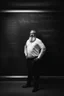 Placeholder: half figure shot photography of a turkish bearded chubby shirtless barechested 44 years old professor in thick glasses, big shoulders, manly chest, standing by completely writed blackboard , front view from the ground, photorealistic, ambient occlusion, side light