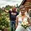 Placeholder: focus of picture on a blonde-haired bride and short dark haired groom serious wedding photo in a country garden, behind the bride and groom in background is a queasy looking man with long dirty blonde hair in an AC/DC t shirt and jeans smiling goofily raising a budweiser can, photobomb, photoreal HD quality