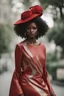 Placeholder: Portrait of a black woman wearing stylish red and silver dress.