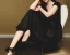 Placeholder: Billie Eilish, sitting on a chair, Black Short Dress, high detail, realistic