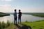 Placeholder: An image of two people exchanging criticism in a constructive and respectful manner, standing on a hill with a lake behind them 4K