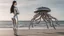 Placeholder: Wide-angle shot of a woman, standing to one side, with dark hair in a silver robotic catsuit, standing on a beach, flying mushrooms with octopus tentacles floating above her