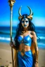 Placeholder: A picture of a beautiful blue faced indian goddess with skin painted blue, blue painted body, blue painted torso, wild black hair, stag antlers, elven ears, golden skirt, holding a staff on a sunny beach