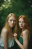 Placeholder: Create a portrait of two young, contemporary women. One is slim and high with blond hair and blue eyes, the second one is chubby, small with ginger hair and green eyes. Women look into eyes each other. Photo taken by a Mamiya M645 camera with a portrait lens on classic medium-format film