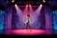 Placeholder: modern stage with a pretty lady in modern clothing dancing, 3D recursive fractal structure animating background
