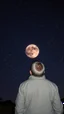 Placeholder: A man is Watching the stars at night , one planet is glowing
