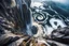 Placeholder: at the base of the rocky mountain peninsula, a great whirlpool waterfalls into deeper unknown depths
