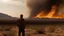 Placeholder: A man looks at a distant fire in the desert