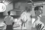 Placeholder: black and white storyboard, wide, on the Foreground there is a man in profile close to the camera and in the background, 3 chefs, scattered throughout the kitchen cooking, frying, cutting