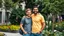 Placeholder: professional photo from happy couple men, one light brown and one black hair man in colorful city cloths t-shirt and jeans. city garden, summer, high realistic, detailed, canon photo, 64 megapixels, perfect composition