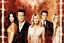 Placeholder: double exposure photo of Matthew Perry as Chandler Bing on TV show "Friends'" set, other castmates Courtney Cox Jennifer Anniston Kudrow Schwimmer Leblanc in background, by Andreas_Lie and Dan_Mountford, ambient lighting, gold and crimson particles, dreamy vapor, nostalgic, moody