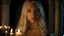 Placeholder: Professional and high quality photo portrait closeup of a beautiful caucasian teen girl with long platinum blonde hair and delicate facial features wearing a medieval gown standing in a candle lit castle bedroom at night looking at viewer.