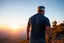 Placeholder: a brawny man with grey hair views sunset from a cliff