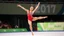 Placeholder: a gymnast lady is showing her spring floors perfomance in olympic games