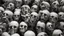 Placeholder: hundreds of anatomically correct, human skulls stacked into a wall unusual neon lighting, high octane, 64k, dystopian, vray, a picture of a dark, comedic, anatomically correct wall of colorful tightly packed skulls of varying sizes and expressions, photo-realistic, insanely meticulous, highly detailed,, 64k, dystopian, vray