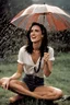 Placeholder: Beautiful 25 year-old Jennifer Connelly is standing outside in a rain shower, smiling, with no rain-coat, umbrella, or hat on, with her head tilted up toward the sky, her tongue sticking out and catching raindrops, as if reliving a pleasant childhood memory.