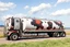 Placeholder: side view of a semitruck for fuel hauling, covered in large cow spots, photo illustration