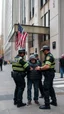 Placeholder: a homeless is arrested by three policemen in front of trump building in New York