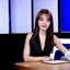 Placeholder: amodern tv studio a beautiful girl perfect face sitting next to desk in talk show looking at camera