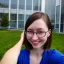 Placeholder: A short haired, female software engineer taking a selfie in front of Building 92 at Microsoft in Redmond, Washington