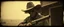 Placeholder: STYLE: gritty 19th-century gothic photography, surrealism.Titian, Rembrandt tactile analog grain, pinhole-camera softness, heavy vignetting, scratched emulsion, rugged irregular photo border. SCENE: alien cowboy, completely absorbed in the mundane task.