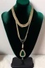 Placeholder: dark green velvet Necklace Mannequin Stand on a luxury table