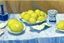 Placeholder: Lemons on a table with a blue napkin, impressionnist oil on canvas by Paul Cézanne, 1887, broad brushstrokes, canvas relief