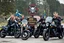Placeholder: a very hard and tuff motorcycle young gang with viking hair, not old, posing with their Harley Davidsson bikes, some of them holding guns and shotguns, a logo sign with Falköpings HD Club, "Fearless sinners" Skulls and bones, skeletons and fire, Sweden vikings DEMONS, Swedish flags on bikes