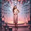 Placeholder: make a picture pretty stage made of metallic blue-gray teme 3d recursive cubic and sphere and cylinder base structures and a beautiful fashion model lady standing with cute in scene with sexy top and pretty pleated midi skirt ,makeup curvy long hair,dynamic camera zoom to full body and pan, dynamic lights.
