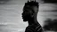 Placeholder: minimal profile shot of an African cyberpunk individual with a striking mohawk hairstyle and intricate shaved patterns on the side of their head, wearing a black and white horizontal thin striped shirt. The background is a blurred, high-contrast mix of black and white lines, suggesting motion and urban settings; overheat, dramatic, cinematic, sudden jolt dynamics, great parallels, great reflections, unsettling shadows, surreal futurist architecture art, surreal liminal space, tribal style, triba