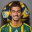 Placeholder: 85mm DSLR color photography of a very detailed headshot fitting all of head and hair in frame. 23-year-old Brazilian soccer player, with and with no facial hair and has a with a small smile, grey background has a soft look on his face has smooth long hair