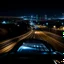 Placeholder: night time, a car dashboard lighting up, a dark road in the windscreen, with a beautiful city in the distance, photo quality