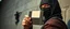 Placeholder: close up on guard holding up a diskette in front of a professional ninja thief climbing a wall during lightening,