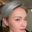 Placeholder: Pretty face of a woman,deep blue eyes, nice nose, pretty lip, simi smile, pointed ears, white skin, white simi gold hair, medium hair, nice neck, sexy soulder, looking in side view, sexy sando,