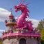 Placeholder: A pink magical dragon on top pf a castle designed in Kuna Molas