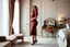 Placeholder: very beautiful sexy lady with beautful dark red midi skirt and blouse standing in a luxury bedroom with high heels next to makeup desk looking to camera