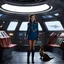 Placeholder: [high res photo directed by J-J Abrams] In the vast expanse of space, aboard a Starfleet vessel, a female starfleet cadet in the iconic miniskirt uniform tends to her unusual companion in the cargo bay area. Her pet dinosaur, a relic from a forgotten era, roams the metallic confines of the ship, its ancient presence juxtaposed against the sleek technology of the starship. As the cadet carefully feeds and interacts with her prehistoric friend, a sense of harmony and camaraderie fills the space.