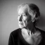 Placeholder: moody charcoal side profile portrait of an older woman, side on profile, studio photography, artistic black and white profile photograph, delicate, highly detailed, chiaroscuro, beautiful composition, delicate arrangement, aesthetic, soft lighting, tender