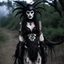 Placeholder: Goth Japanese demonic alien xenomorph clown woman as a xenomorph as a lingerie model with "black lace" fantasy in a xenomorph with tar and trad goth costume gothic killstar clothing with lace and black slime tar designs on the clothing in the movie "blair witch project" at night with moonlight, from a 1970s movie,