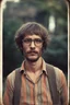 Placeholder: bohemian young ugly man with Parisian bohemian look and glasses of colours and poor and short short short and poor hair on the head with receding hairline. Farsightedness glasses with big eyes. Shirt beard in the head. Vintage look and feel like photo style-of the 70s