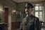 Placeholder: ww1 cop talking close-up standing up looking to the camera, ww1 mansion living room background