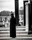 Placeholder: photo of a hoodless grim reaper wearing a suit, highlighting shiny areas of the skull, sitting outside a cemetery with a welcome sign, wearing suit, rim lighting, studio lighting, looking at the camera, dslr, ultra quality, sharp focus, tack sharp, dof, film grain, Fujifilm XT3, crystal clear, 8K UHD