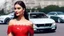 Placeholder: full body shot of young, beautiful Ozbek brunette with a perfect happy face with make up, wearing red lace off shoulder dress, over a luxury roof less car in amodern city street.