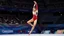 Placeholder: Please provide a detailed Photo of a female gymnast performing her routine on the floor exercise at the Olympic Games. Include specific elements of her performance, such as her choreography, the difficulty of her moves, her artistry, and how she engages the audience. Additionally, describe the atmosphere of the event, the reactions of the crowd, and any notable aspects of her presentation. The output should be structured in a way that captures the excitement and technical skill of the performanc